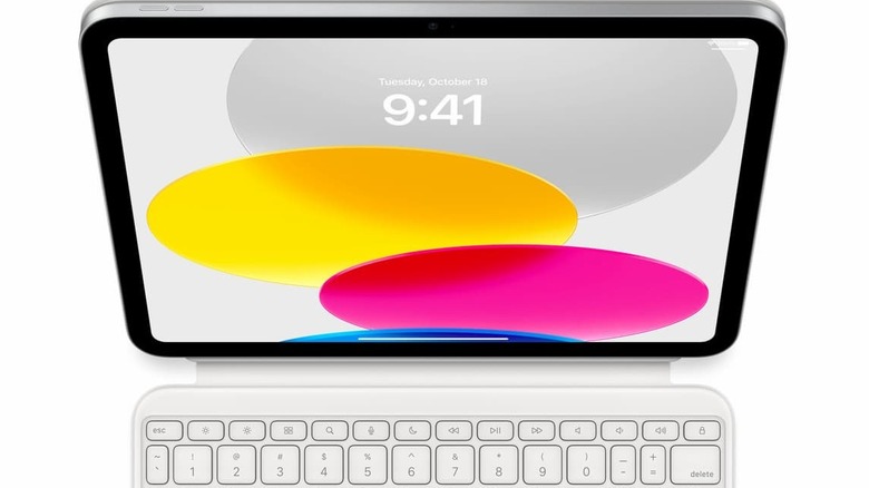 An iPad with the time displayed in front of colorful circles.