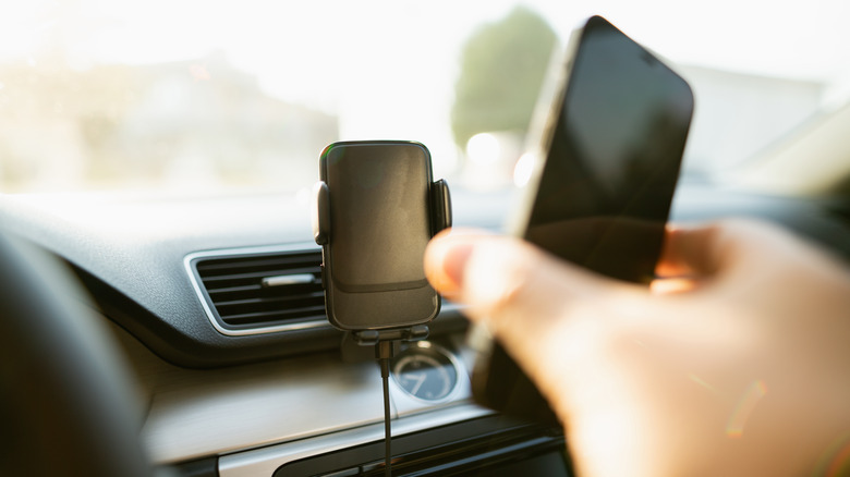 Person attaching phone to car mount