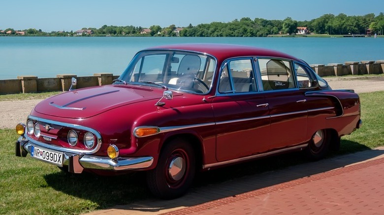 Red Tatra 603 parked by the water