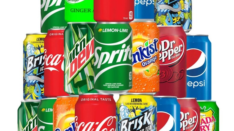 sodas cans from different brands piled one over the other.