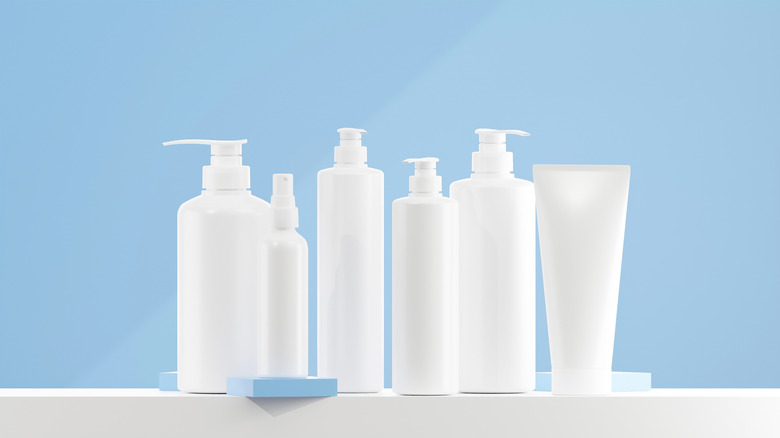 White bottles of soap and lotions with no label on a light blue background.