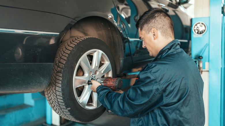 A mechanic removing a car tire