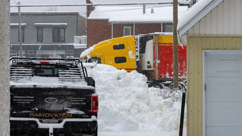 Pickup trucks covered in snow