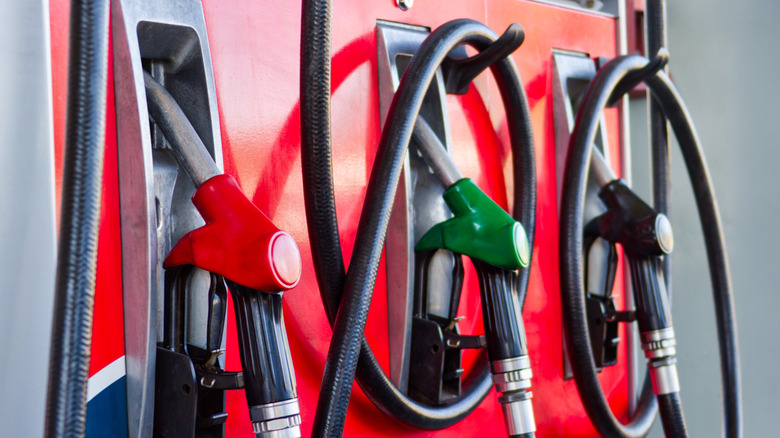 Fuel nozzles resting against pumps