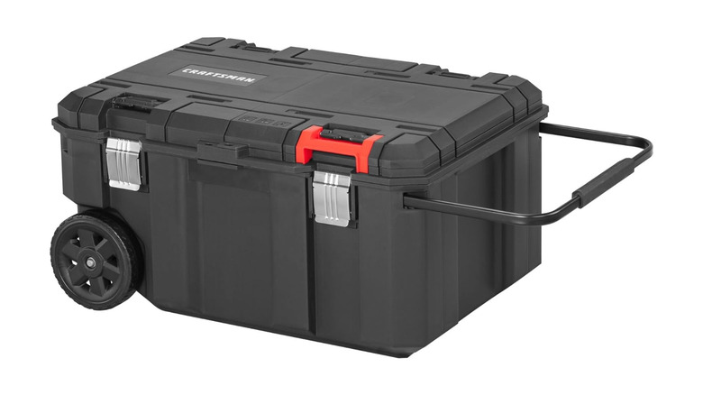 A large, black toolbox with wheels labeled Craftsman