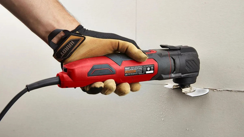 Bauer oscillating multi-tool cutting into drywall