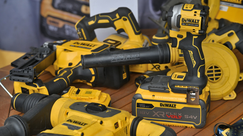 Variety of DeWalt power tools on a table.