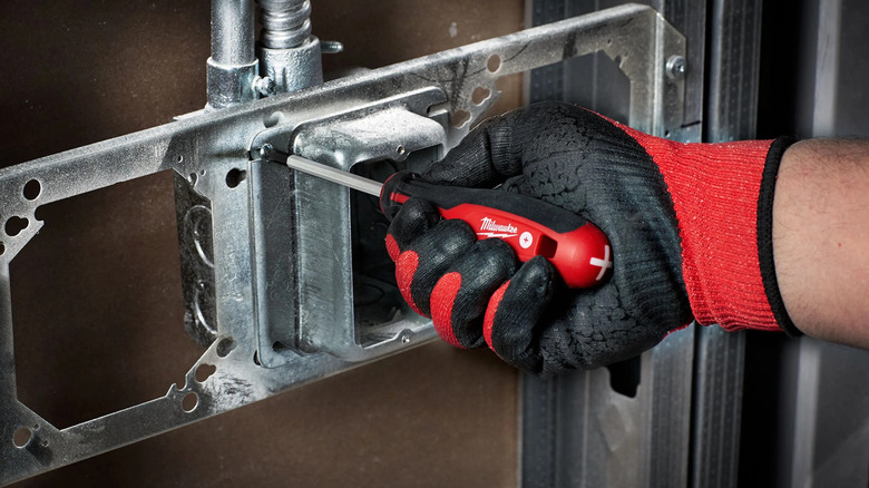 Worker using a Milwaukee screwdriver