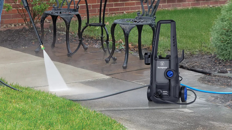Westinghouse pressure washer cleaning a yard