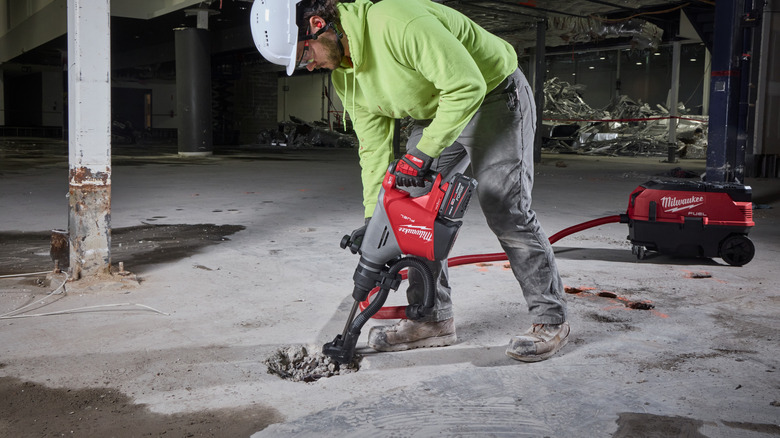 Man uses a Milwaukee demolition hammer