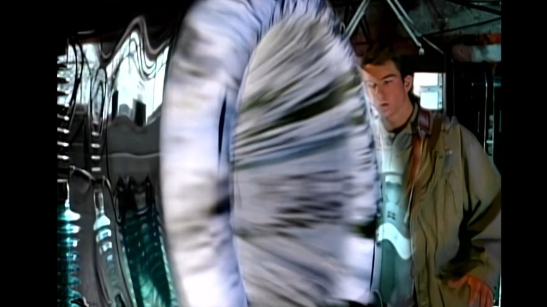 Quinn Mallory (Jerry O'Connell) in front of sliding portal