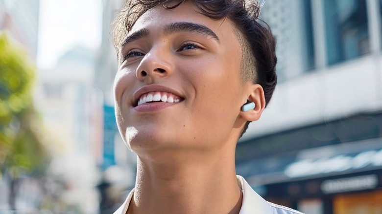 Closeup of person wearing Anker Soundcore earbuds