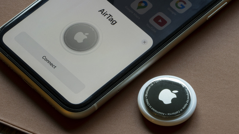 Apple AirTag and smartphone screen