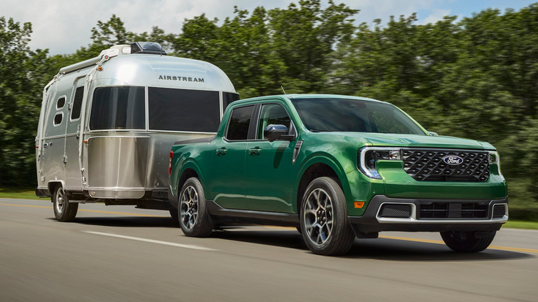 A green 2025 Ford Maverick towing an Airstream