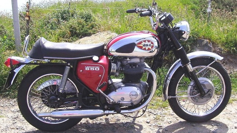 red and silver BSA A65 Lightning motorcycle on a track