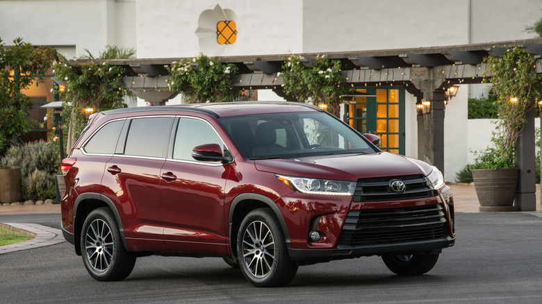 A red 2018 Toyota Highlander SUV parked outside a building.