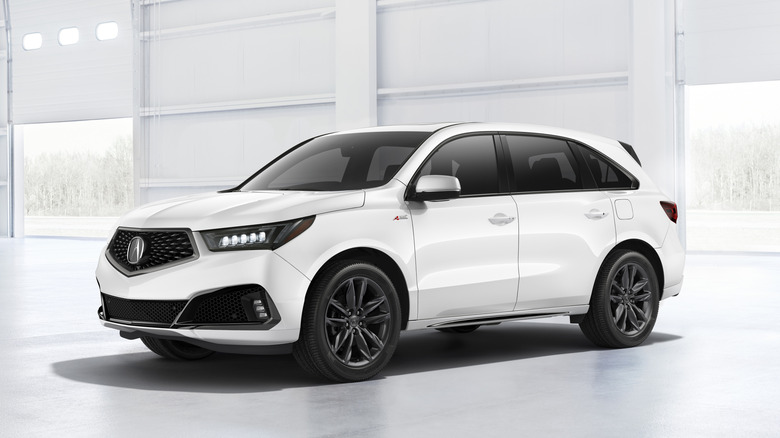 A white 2020 Acura MDX parked in a clean garage.