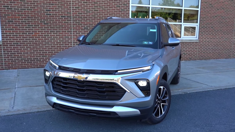 A gray 2026 Chevrolet Trailblazer parked in front of a brick building.