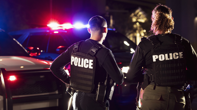 Police with flashing police cars