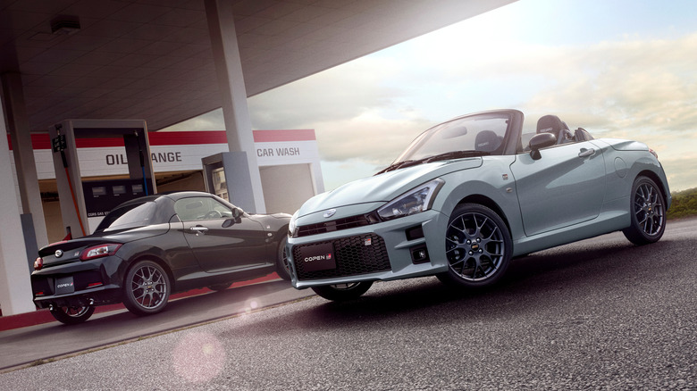 Two examples of the Toyota Copen GR Sport at a gas station