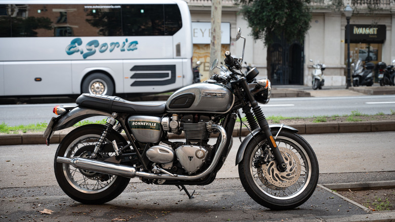 A classc Triumph Bonneville T120R in gray and green parked at the side of a street.