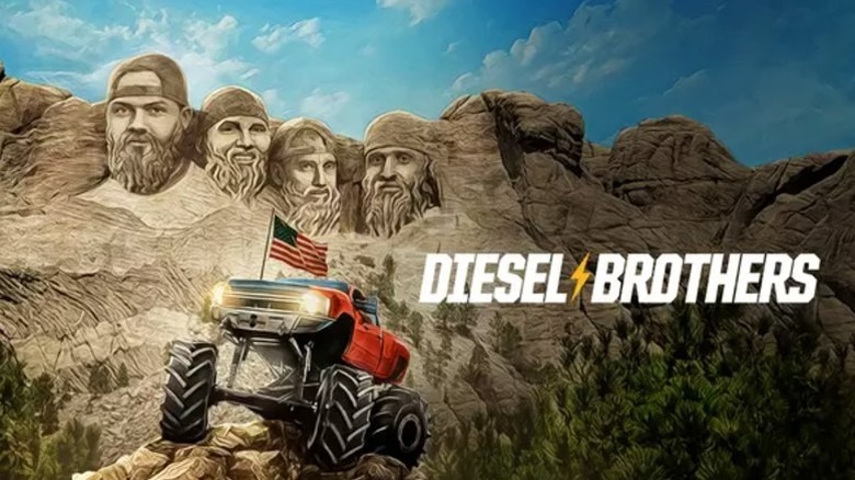 A monster truck climbing a mountain, a parody of Mount Rushmore in the background.