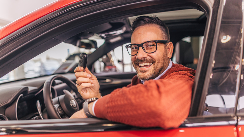 A man in his car smiling