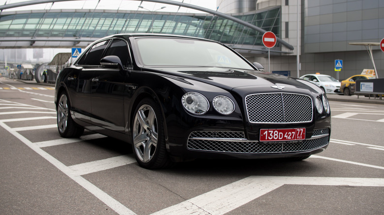 View of a diplomatic license plate on a black Bentley
