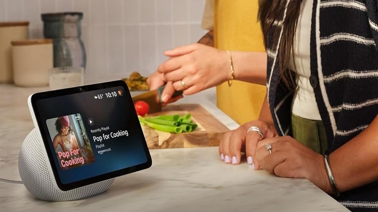 Two people listening to an Echo smart display while cooking