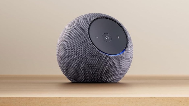 the Echo Dot Max smart speaker on a wooden table.