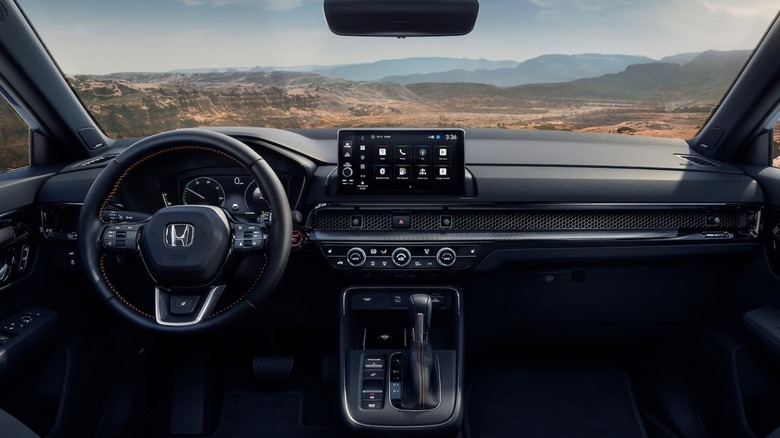 The black interior of the 2026 Honda CR-V hybrid model, parked outdoors.