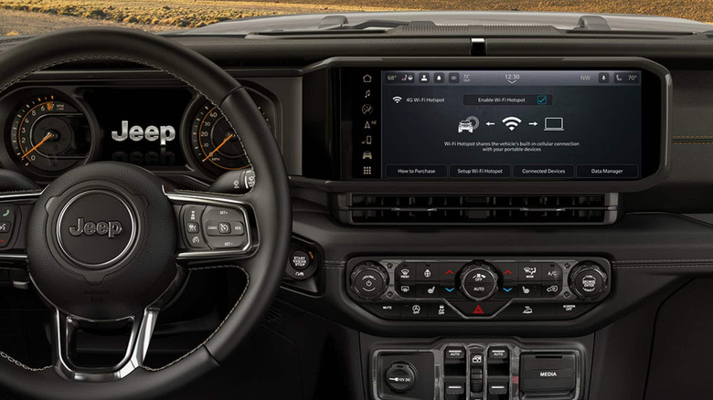 The gorgeous matte-black interior of the 2026 Jeep Wrangler, with the infotainment display front and center.