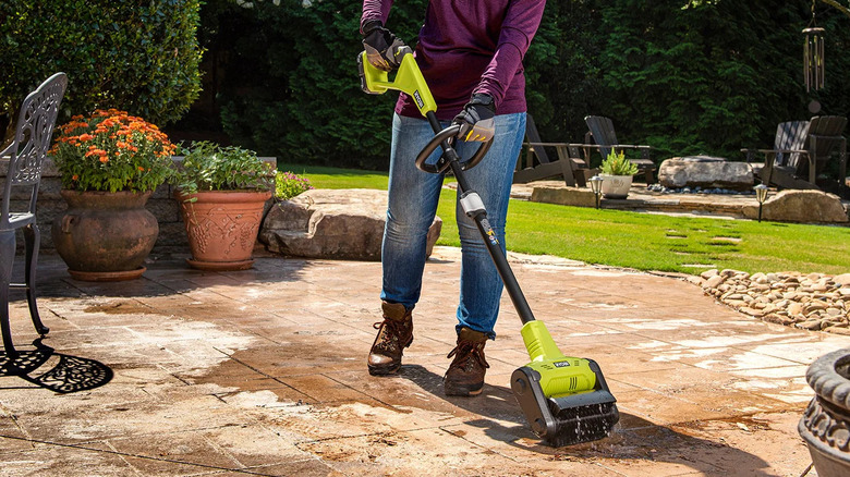 Woman using Ryobi patio sweeper