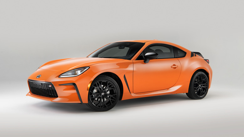 A side on shot of an orange 2023 Toyota GR86