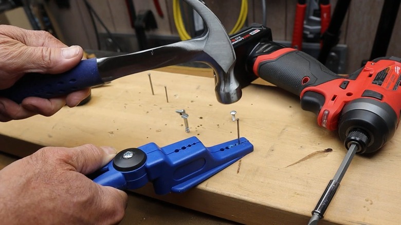 Nail in nail holding pliers