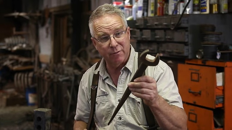 Man holding a spud wrench