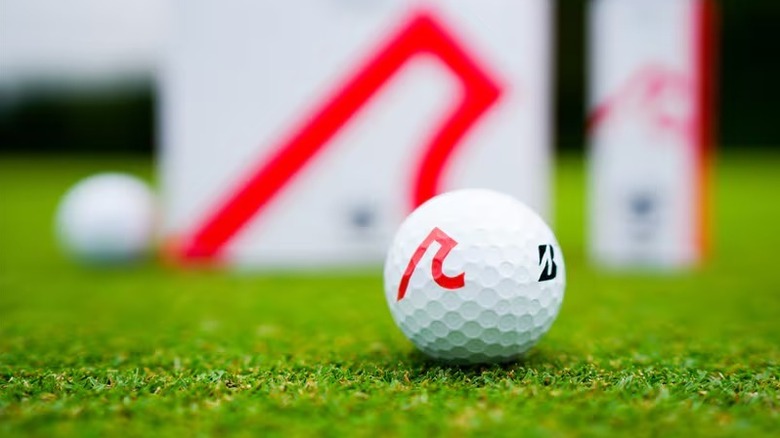 Bridgestone golf ball on the grass with its box behind