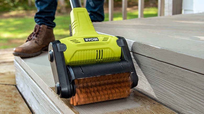 A person plugging in a Ryobi power station to the wall