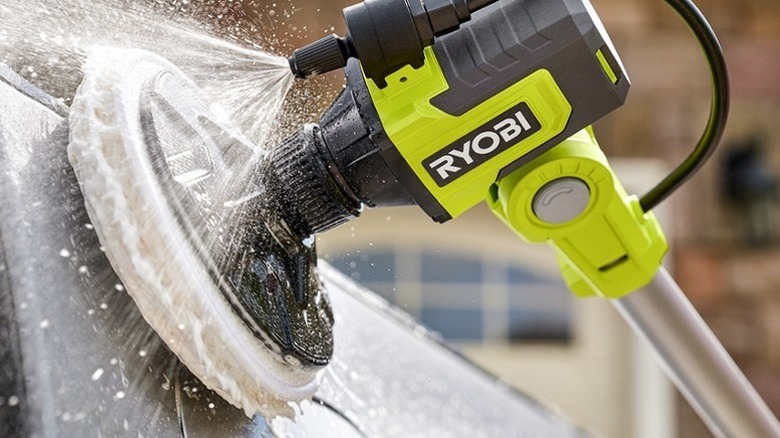 Ryobi 18V One+ Soap Dispensing Telescoping Scrubber Kit scrubbing a surface