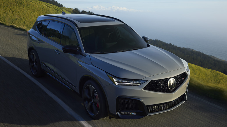 Gray Acura MDX driving on a mountain road