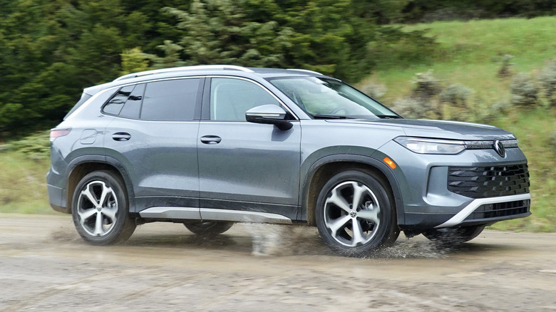 2025 Volkswagen Tiguan SE on a dirt road with puddles