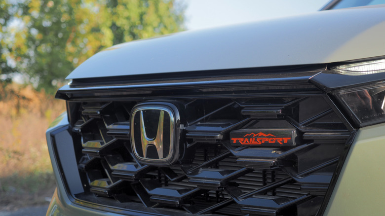 2026 Honda CR-V TrailSport Hybrid badge detail on grille