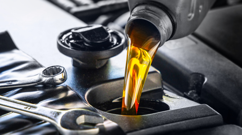 Motor oil being poured into engine