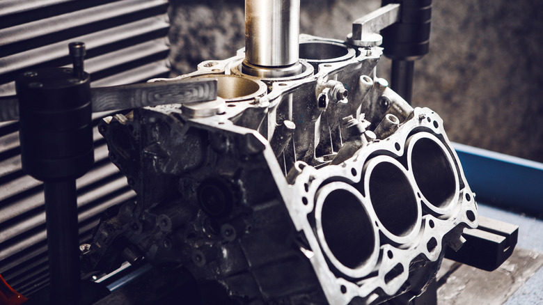 A close-up of a 3-cylinder engine block repair on a CNC machine.