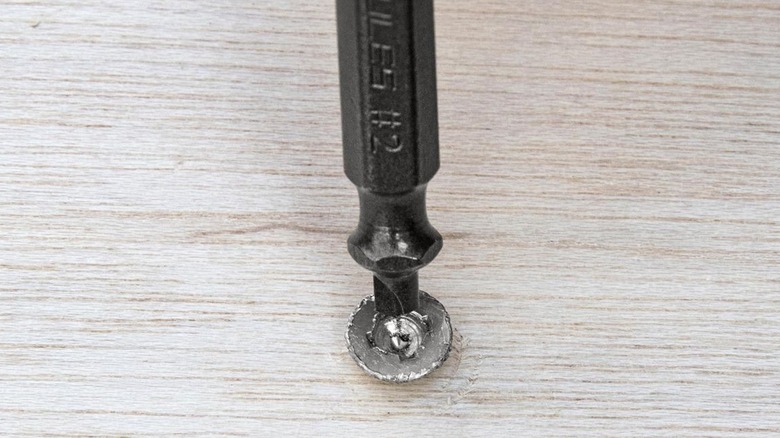 Screw extractor tool going into stripped screw