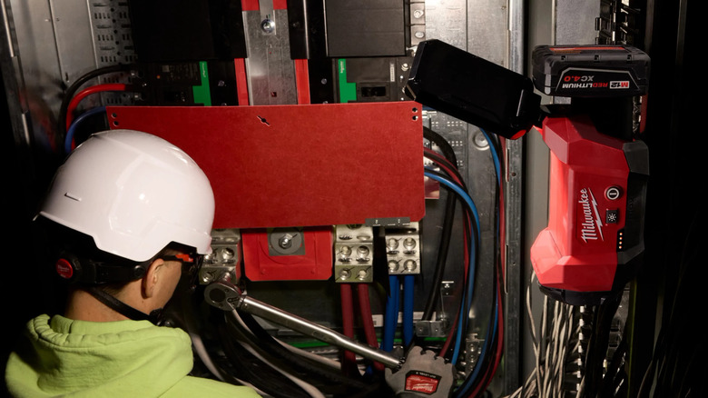 Milwaukee M12 flood light illuminating a workspace
