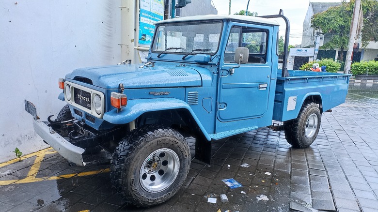 Blue Land Cruiser J45 pickup parked outside building