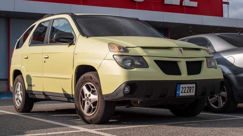 yellow Pontiac Aztek in a store parking lot