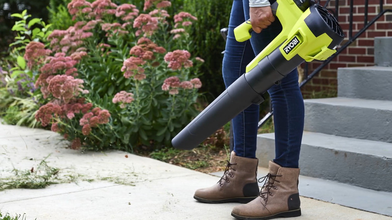 Ryobi blower being used on sidewalk
