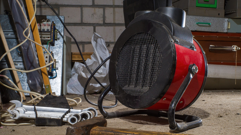 A space heater plugged in in a garage.